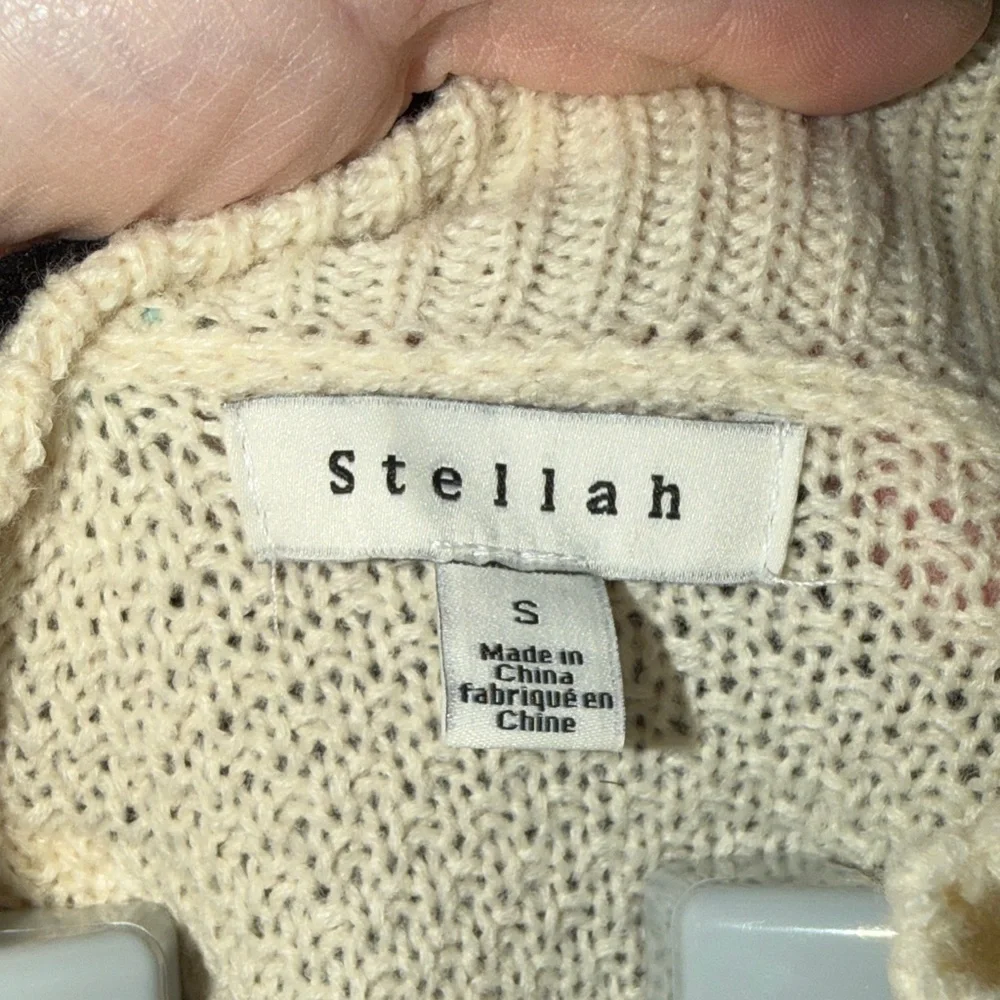 Stellah Ivory Sweater with Black Ruffle Accents